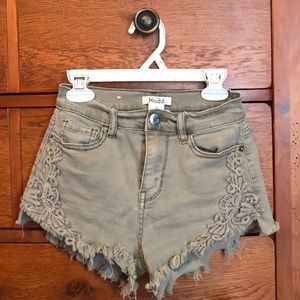 Green denim shorts with floral pattern